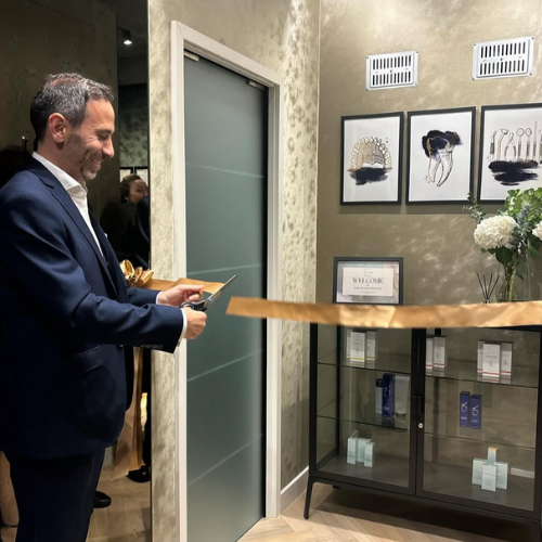 Dr Mohammad Husban cutting a ribbon at a clinic doorway